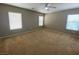 Spacious bedroom with carpet flooring, ceiling fan, and neutral decor at 2604 Courlan Dr, North Las Vegas, NV 89084