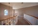 Upstairs hallway with curved railing and carpet at 344 Hedgehope Dr, Las Vegas, NV 89183