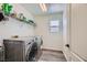 Bright laundry room with washer, dryer, and ample shelving at 10950 Cherokee Landing St, Las Vegas, NV 89179