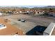 Aerial view of a vacant lot with two cars parked, adjacent to a building at 241 Palo Verde Dr, Henderson, NV 89015