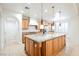 Island kitchen with granite countertops and wood cabinets at 207 Crooked Putter Dr, Las Vegas, NV 89148