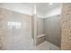 Large walk-in shower with granite tile and built-in seat at 207 Crooked Putter Dr, Las Vegas, NV 89148