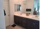 Elegant double-sink bathroom with dark brown vanity and large mirror at 7334 N Decatur Blvd # 6, North Las Vegas, NV 89084