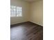 Bright bedroom with large window and wood-look flooring at 3318 N Decatur Blvd # 1173, Las Vegas, NV 89130