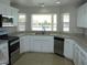 Modern kitchen with white cabinets, tile backsplash, and stainless steel appliances at 3020 Peggy Ave, Pahrump, NV 89048