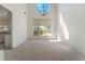 Bright dining room features a high ceiling, large window, and elegant chandelier at 8535 Belcastro St, Las Vegas, NV 89113