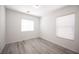 Spacious bedroom with gray vinyl flooring and two windows at 9570 Summer Furnace St, Las Vegas, NV 89178