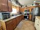 Kitchen with wood cabinets, granite countertops, and stainless steel appliances at 130 Spring Mountain Vista Ave, Pahrump, NV 89060