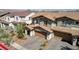 Aerial view of a two-story house with a two-car garage and a paved driveway at 329 Brockbank Pl, Henderson, NV 89011