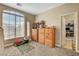 Bedroom with wooden dresser, large window, and access to another room at 7310 Heggie Ave, Las Vegas, NV 89131