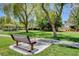 Serene community park with grassy areas, trees, a gazebo, and a bench at 7310 Heggie Ave, Las Vegas, NV 89131