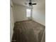 Well-lit bedroom featuring carpeted floors and a ceiling fan at 2818 Turnstone Ridge St, Henderson, NV 89044