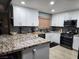 Modern kitchen featuring white cabinets, granite countertops, and stainless steel appliances at 2851 S Valley View Blvd # 1119, Las Vegas, NV 89102