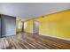 Large living room with wood-look floors and yellow walls at 870 B # 606, Boulder City, NV 89005