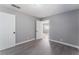 Bedroom with gray walls, wood-look flooring, and access to another room at 1225 Lawry Ave, Las Vegas, NV 89106