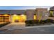 Modern garage with glass panels and well lit driveway at 455 Tranquil Peak Ct, Henderson, NV 89012