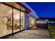 Modern patio with hot tub, sleek glass doors opening to dining area, and city views at 455 Tranquil Peak Ct, Henderson, NV 89012