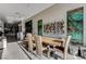 Modern dining area with large wood table and contemporary artwork at 455 Tranquil Peak Ct, Henderson, NV 89012