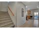 Carpeted staircase leading to the upper level and kitchen view at 6012 Valley Flower St, North Las Vegas, NV 89081