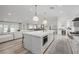 Modern white kitchen with large island and high-end appliances at 2250 Bowie Cir, Henderson, NV 89014