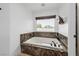 Relaxing bathtub with marble surround and built-in TV at 2250 Bowie Cir, Henderson, NV 89014