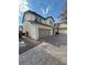 Two story house with tan garage door and gray brick driveway at 927 Sunny Acres Ave, North Las Vegas, NV 89081