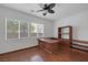 Home office featuring wood flooring, built-in shelving and ceiling fan at 9524 Grand Grove Ct, Las Vegas, NV 89149