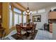 Charming dining room with wood table and chairs, and a chandelier at 10920 Black Ledge Ave, Las Vegas, NV 89134