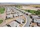 Aerial view of houses in a community with a golf course and desert landscape at 4484 E Cactus Canyon Dr, Pahrump, NV 89061