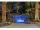 Tranquil illuminated grotto and waterfall feature in backyard oasis at 27 Eagles Landing Ln, Las Vegas, NV 89141