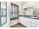 Double vanity bathroom with white cabinets and dark countertops at 2846 Mount Hope Dr, Las Vegas, NV 89156