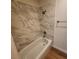 Updated bathroom with a bathtub and marble tile shower surround at 733 Heritage Vista Ave # 0, Henderson, NV 89015