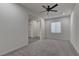 Spacious bedroom with ceiling fan and gray carpeting at 6630 Windy Palm St, North Las Vegas, NV 89086