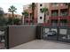 Private balcony overlooking parking lot, partially covered with a wall at 63 E Agate Ave # 202, Las Vegas, NV 89123