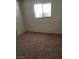 Simple bedroom with neutral carpeting and a window at 4555 Payson Ave, Las Vegas, NV 89115