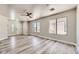 Bright living room with neutral walls, wood-look floors, and ceiling fan at 1038 Silver Creek Ave, Las Vegas, NV 89183