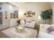 Spacious living room with cream colored sofas, a coffee table and decorative artwork at 9809 Gerald Ct, Las Vegas, NV 89134