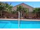 Inviting backyard pool with palm trees and a view of the home at 4116 Mattray St, North Las Vegas, NV 89032