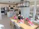 Elegant dining area with a farmhouse table, chairs, and a view to the kitchen at 107 Orchestral Ln, Henderson, NV 89011