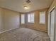 Simple bedroom with carpet flooring and three windows with shutters at 1337 Via Savona Dr, Henderson, NV 89052