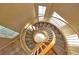 Elegant spiral staircase with wood railings and carpet steps at 1337 Via Savona Dr, Henderson, NV 89052