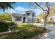 Two-story house with gray siding, landscaped yard, and a two-car garage at 7621 Natures Song St, Las Vegas, NV 89131