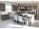 Modern kitchen featuring gray cabinetry, quartz countertops, and breakfast bar seating at 4121 Sigalas Ave, North Las Vegas, NV 89081