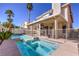 Dual pool and spa with a covered patio and lush landscaping at 2244 Brighton Shore St, Las Vegas, NV 89128