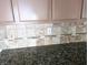 Kitchen backsplash with stone tile and granite countertops at 5115 Blossom Ave, Las Vegas, NV 89142