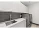 Modern laundry room with stainless steel sink and updated appliances at 31 Vista Outlook St, Henderson, NV 89011