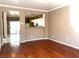 Living room with hardwood floors and an open view to the kitchen at 7451 Grizzly Giant St, Las Vegas, NV 89139