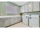 Laundry room with gray cabinets, washer, and dryer at 198 Shaded Canyon Dr, Henderson, NV 89012