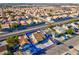 High-angle aerial view showcasing a single-story home with a pool and surrounding neighborhood at 3827 Silent Hill Dr, Las Vegas, NV 89147