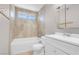 Bathroom with tiled shower, white vanity, and modern fixtures at 3827 Silent Hill Dr, Las Vegas, NV 89147